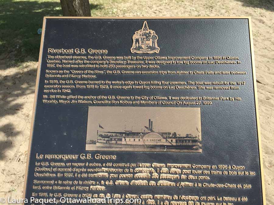 Black and gold historical plaque with photo of early 1900s passenger steamboat.