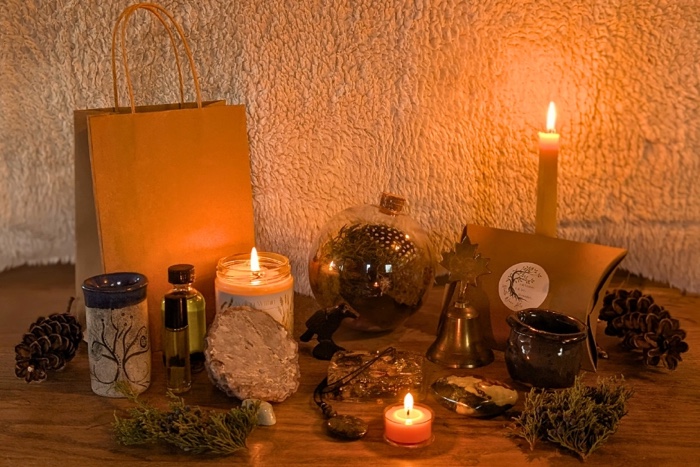 yuletide-boutique_ninth-wave-arts_855x570px - 1 - Ottawa Road Trips ornaments, pinecones and glowing candles on a wooden table