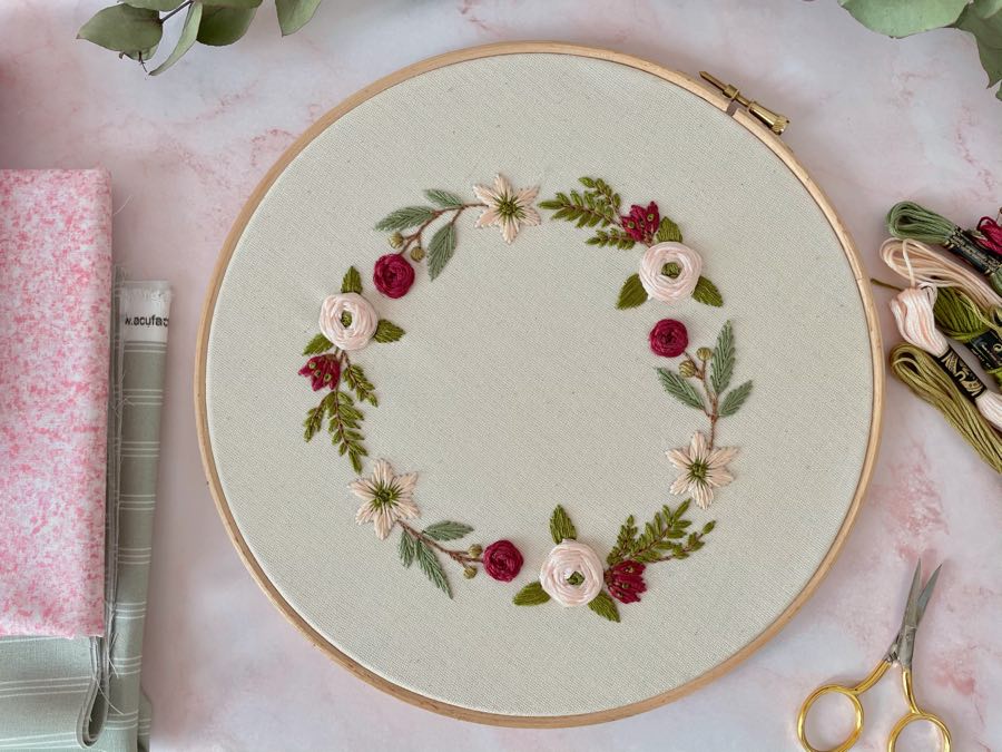 embroidery hoop with a small circular floral design on the fabric inside it