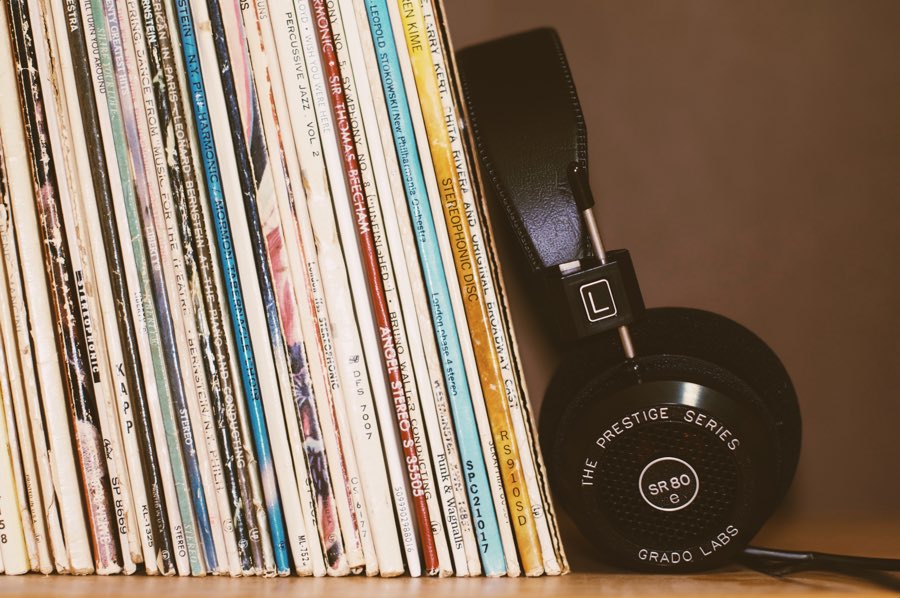 records on a shelf with a set of headphones