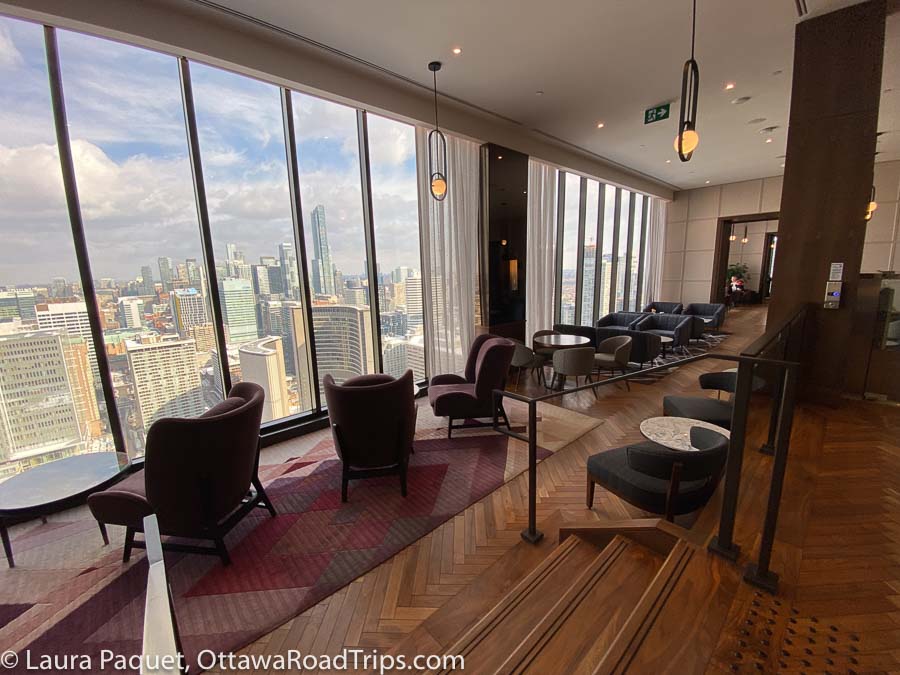 wing-back chairs in parquet-floored club lounge at the sheraton centre toronto hotel, overlooking toronto city hall.