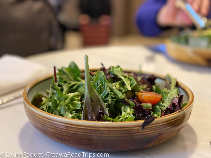 small green salad in a shallow brown bowl