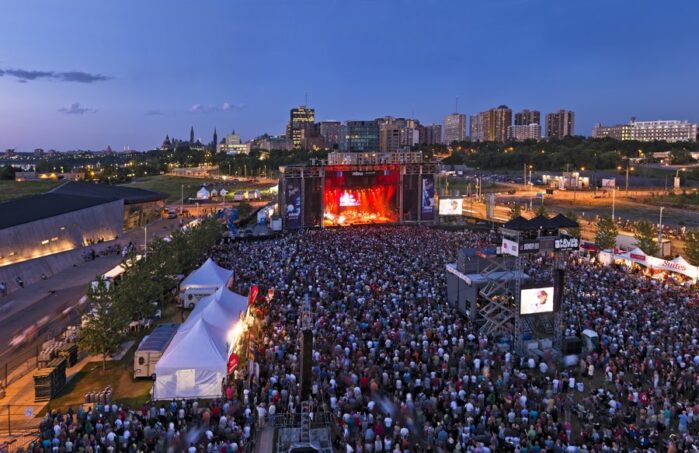 crowds in front of stage at dusk at RBC Ottawa Bluesfest on LeBreton Flats