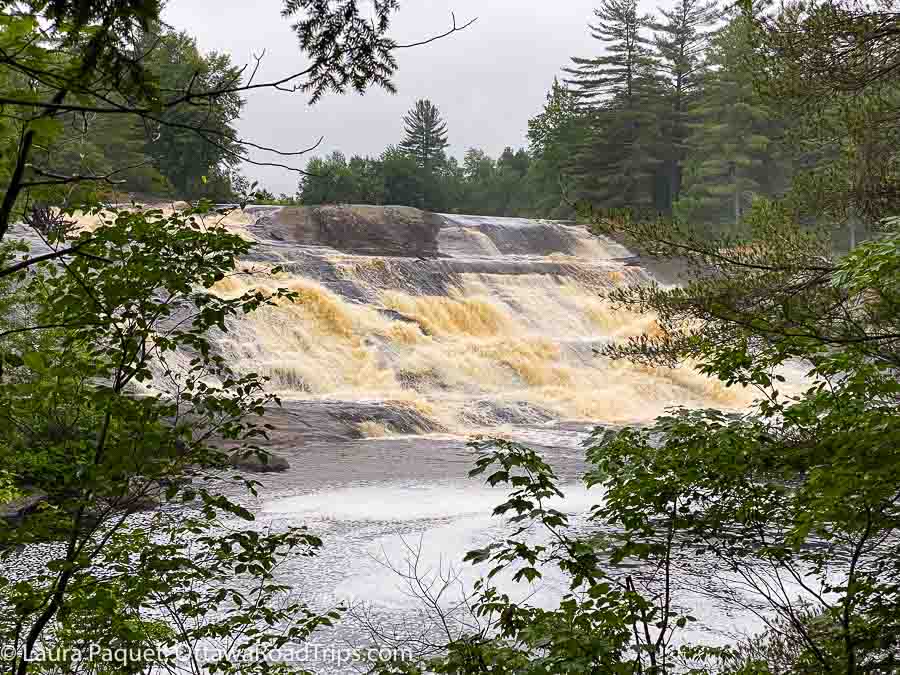 lampson falls, a wide waterfall framed by trees in st lawrence county new york.