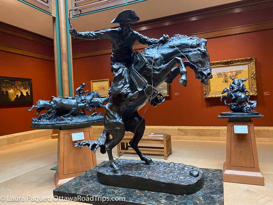 bronze sculpture by frederic remington of a cowboy on a rearing horse
