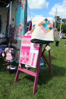 quilts draped over a chair outdoors