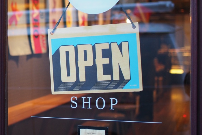 photo of an "open" sign on a shop door