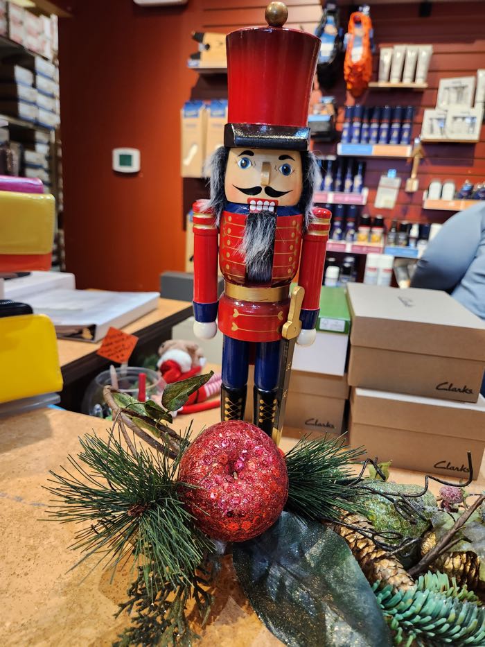 closeup of a toy soldier nutcracker surrounded by shoeboxes