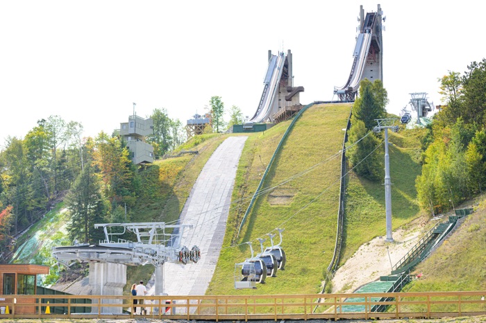 twin ski jumps in summer with gondolas at the base