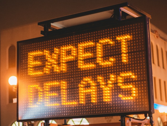 large illuminated sign reading "expect delays"