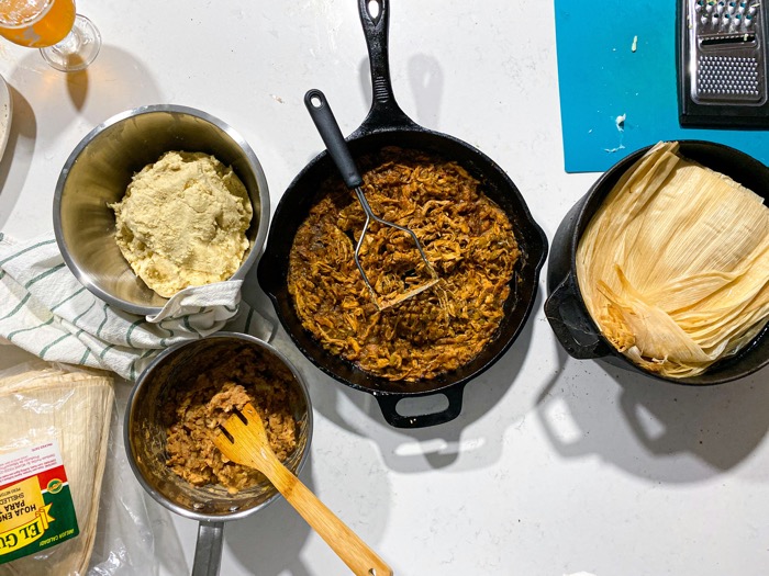 overhead view of pans filled with tamale ingredients.