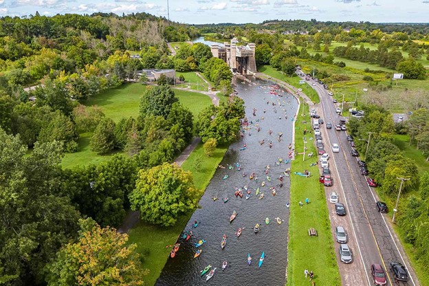 Aerial view of lots of canoes and kayaks on the Trent-Severn Waterway near the Peterborough Liftlock during Lock & Paddle 2023.