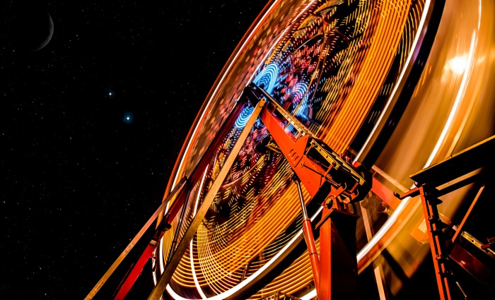 time-lapse exposure of an illuminated ferris wheel at night