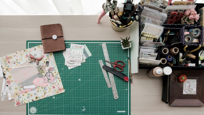 ruler, cutting board and other crafting supplies, on a desk