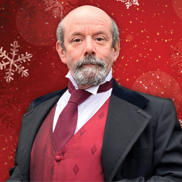 a christmas carol pierre credit jamine ackert - Ottawa Road Trips man in victorian suit with snowflakes in background.