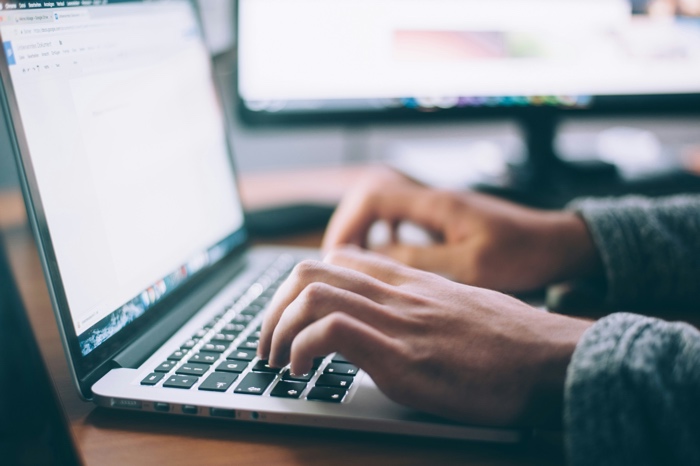 glenn-carstens-peters-writing laptop-unsplash - Ottawa Road Trips closeup of hands typing on a laptop