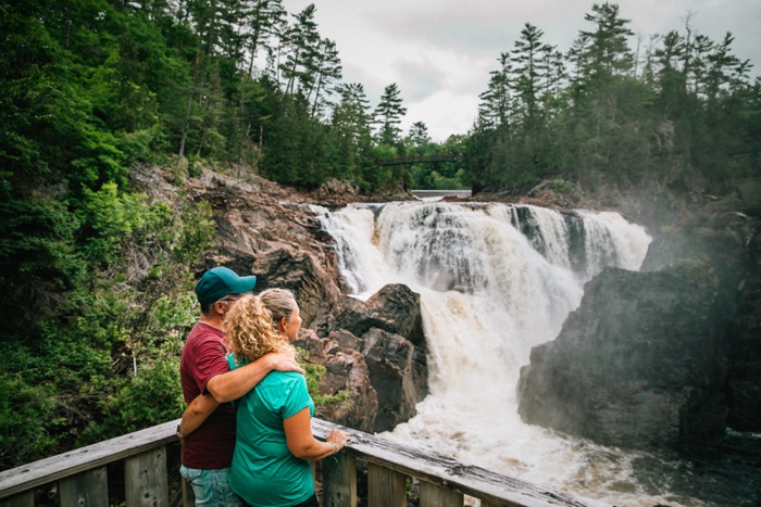 ld myriam baril-tessier chutes coulonge 700 - Ottawa Road Trips man and woman standing on a wooden platform overlooking a rushing waterfall.