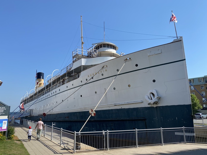 exterior of large blue and white boat, in dry dock
