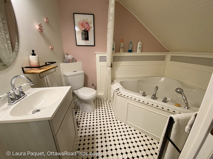 bathroom with large tub and black-and-white tiled floor