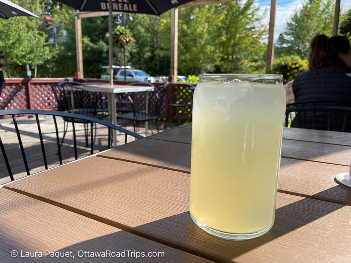 glass of lemonade on a wooden table on a patio