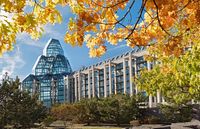 exterior of national gallery of canada framed by fall trees