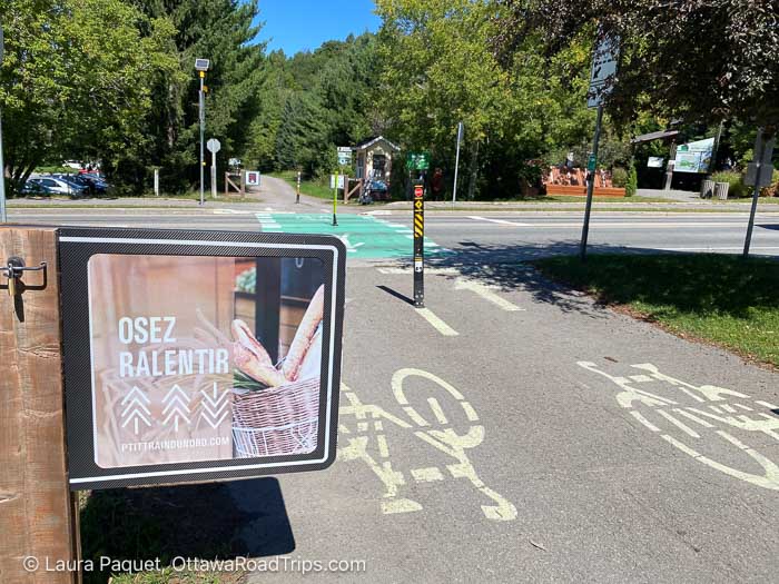 sign reading osez ralentir with a picture of a basket of baguettes