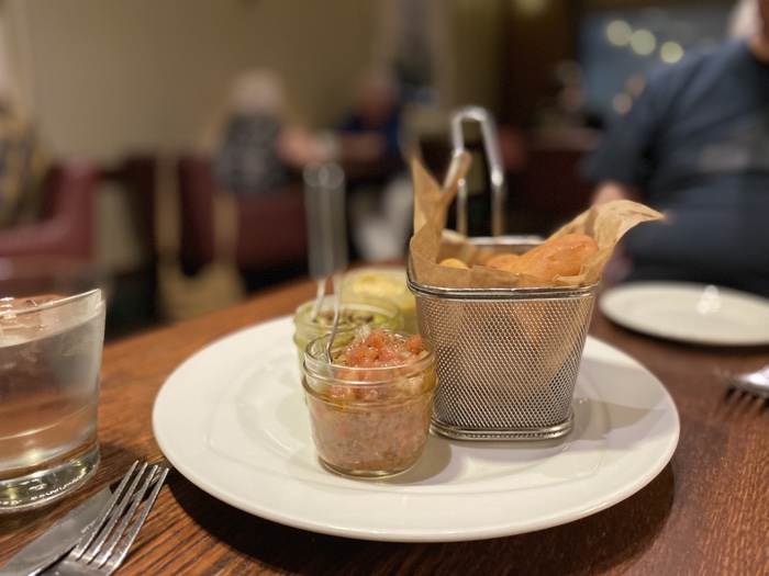 chelsea hotel dips naan appetizer - Ottawa Road Trips wire basket of naan with three small glass jars of dips