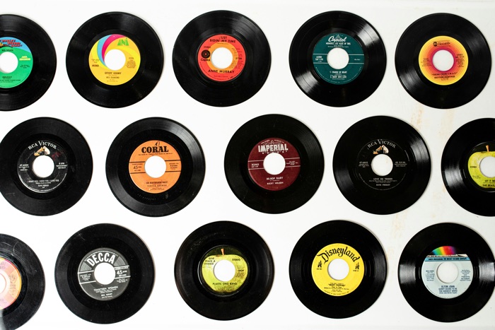 meagan-stone-records 45s-unsplash - Ottawa Road Trips a dozen classic 45rpm records on a white surface