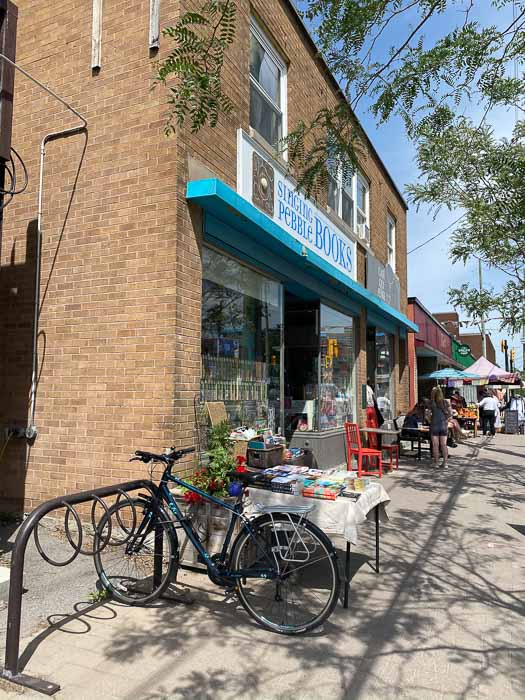 exterior of singing pebble books in summer