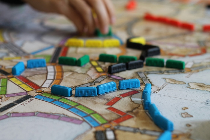 dave-photoz-ticket to ride-unsplash - Ottawa Road Trips close up of plastic train cars on a ticket to ride board