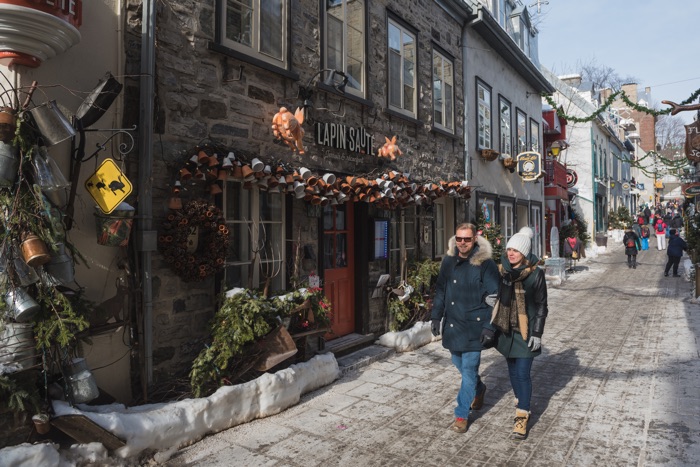 petit-champlain tq-018166_credit_region_de_quebec_copyright_gouvqc_francis_gagnon - Ottawa Road Trips people in winter clothes walking past stone buildings on rue petit-champlain in quebec city