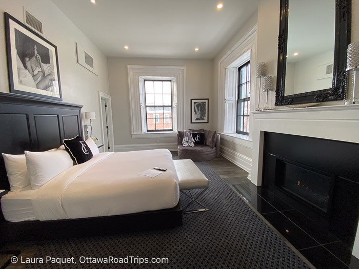 frontenac suite with fireplace - Ottawa Road Trips hotel room with cream and brown decor, large windows, fireplace