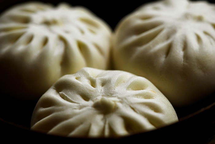 kevin-kevin-bao-unsplash - Ottawa Road Trips closeup of three bao buns in a black dish