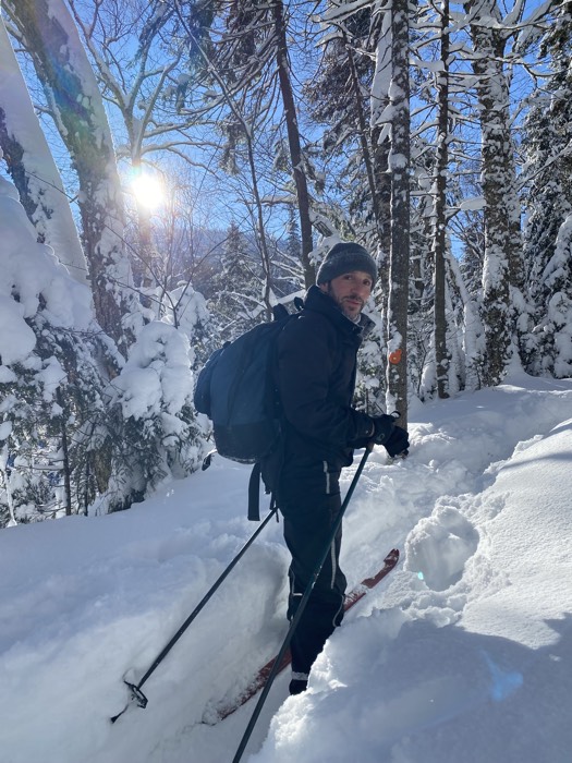 les routes blanches 3 sized - Ottawa Road Trips man skiing through thick snow turning to look at camera