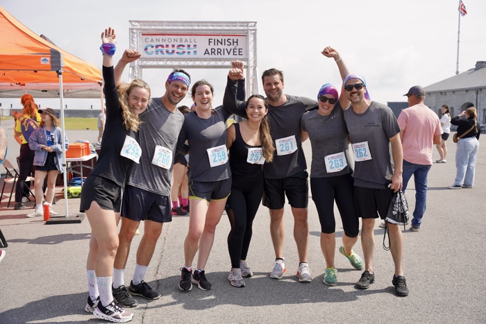 forthenry_cannonballcrush_202400002 sized - Ottawa Road Trips runners wearing race numbers cheering at finish line of cannonball crush