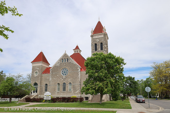 grey stone church with bright red peaked roofs.