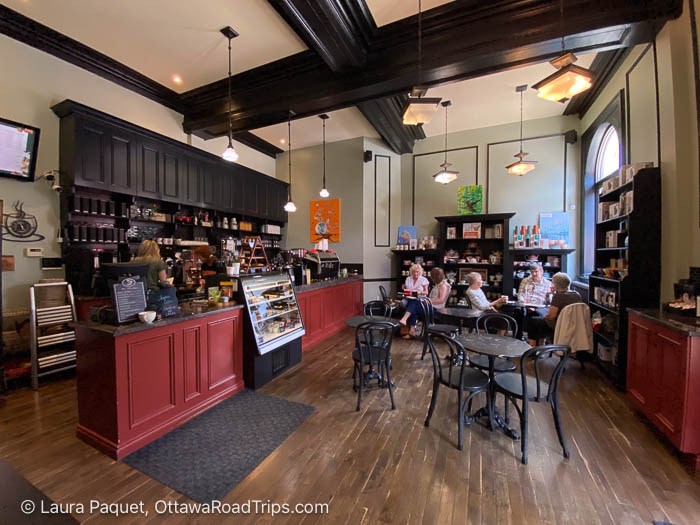 coffee shop with dark panelled cabinets and dark wood coffered ceiling