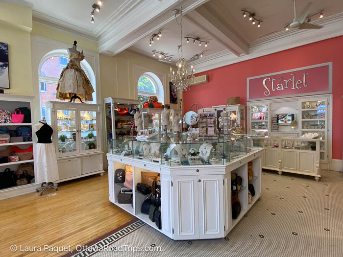 starlet shop with pink wall, arched window, display cases of jewellery and purses, in napanee, ontario