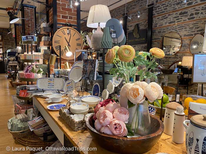 shop with stone walls and displayof dishes, clocks and mirrors