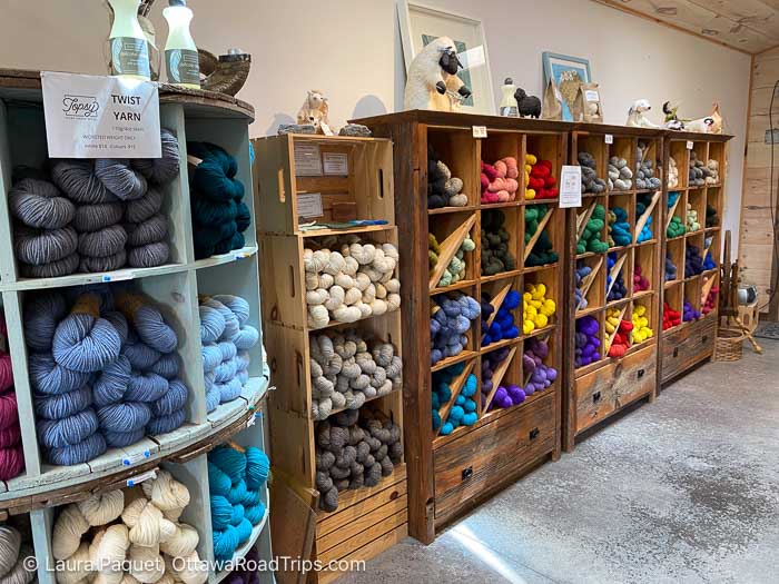 shelves filled with colourful skeins of yarn at topsy farms on amherst island