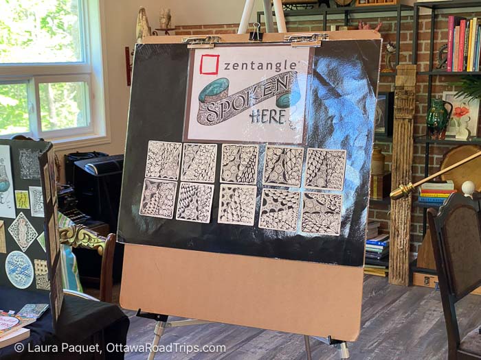 10 square zentangles displayed on an easel