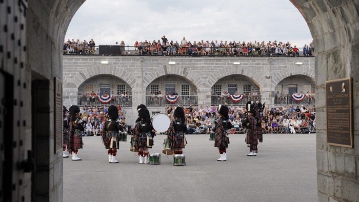 forthenry_tattoo_405 - Ottawa Road Trips band in kilts playing before spectators on bleachers inside old limestone parade square