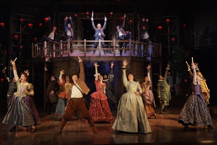 2024 on the run something rotten - Ottawa Road Trips actors in renaissance costumes singing, with their arms flung upward.